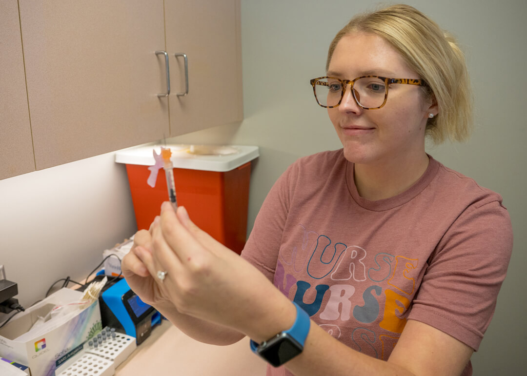 nurse preparing an immunization in a needle